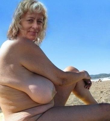 Old whore with huge boobs on the beach