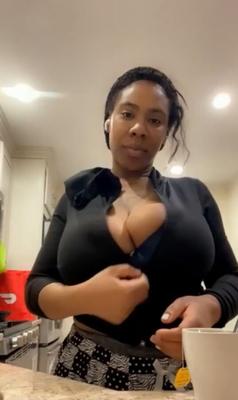 Flashing her big black tits